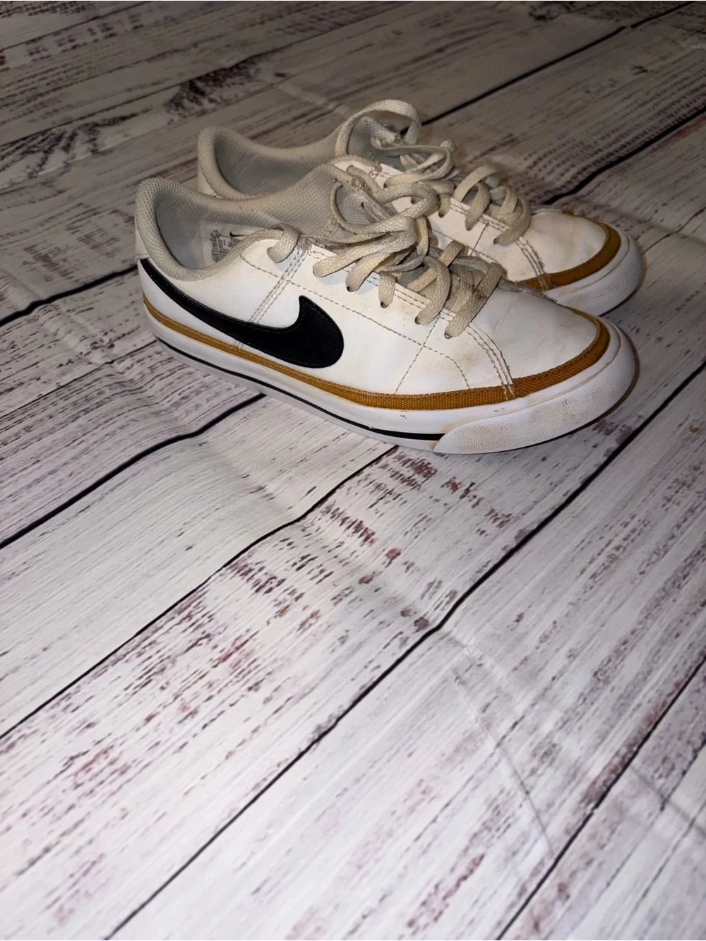 Nike White Low-Top Sneakers with Black Swoosh and Tan Accent